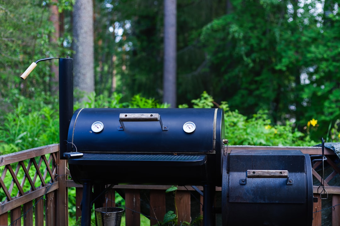 A bbq grill sitting on top of a wooden deck